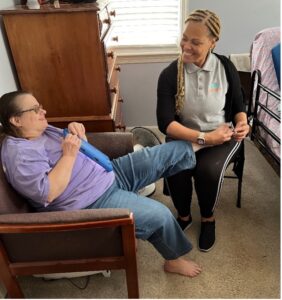 One of our Mentor Care Pros, Iris, providing one of her clients, Ms. Helen, a pedicure.